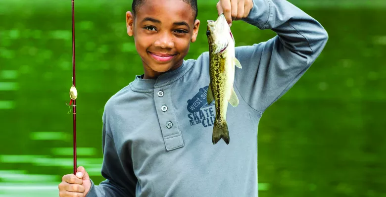 A kid shows off the fish he caught at Montgomery Bell State Park, TN