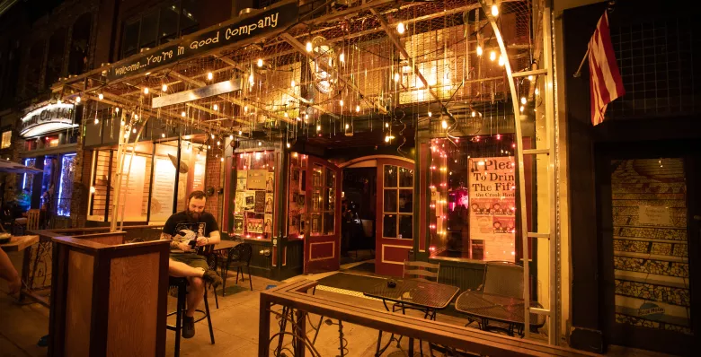 The outside of Preservation Pub lit up at night in Knoxville TN