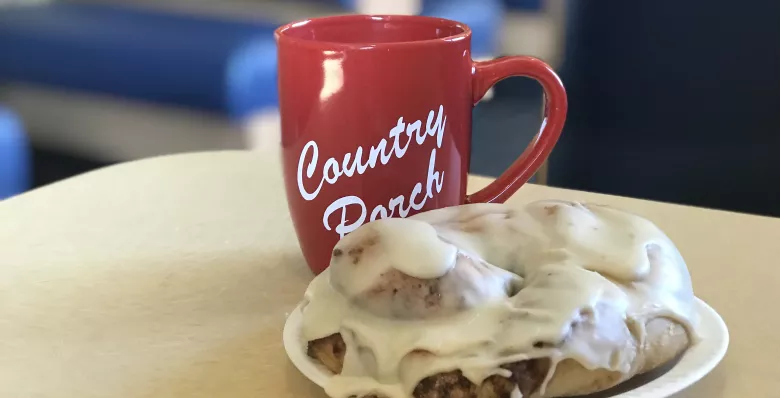 A large cinnamon roll and cup of coffee at Country Porch in Monterey