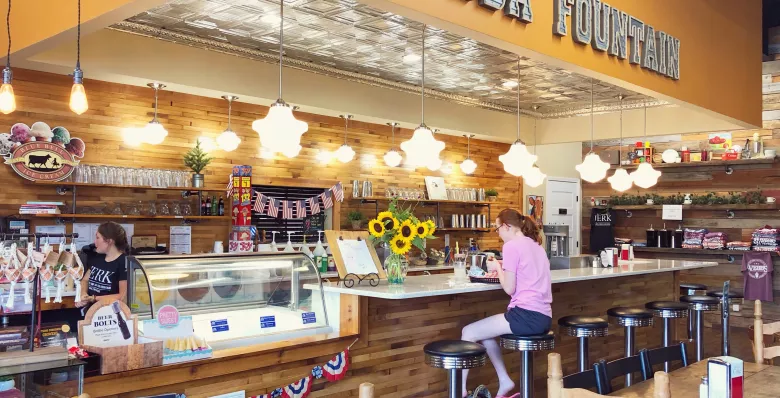 Girl at old-time soda fountain counter at Webbs Pharmacy in Smithville